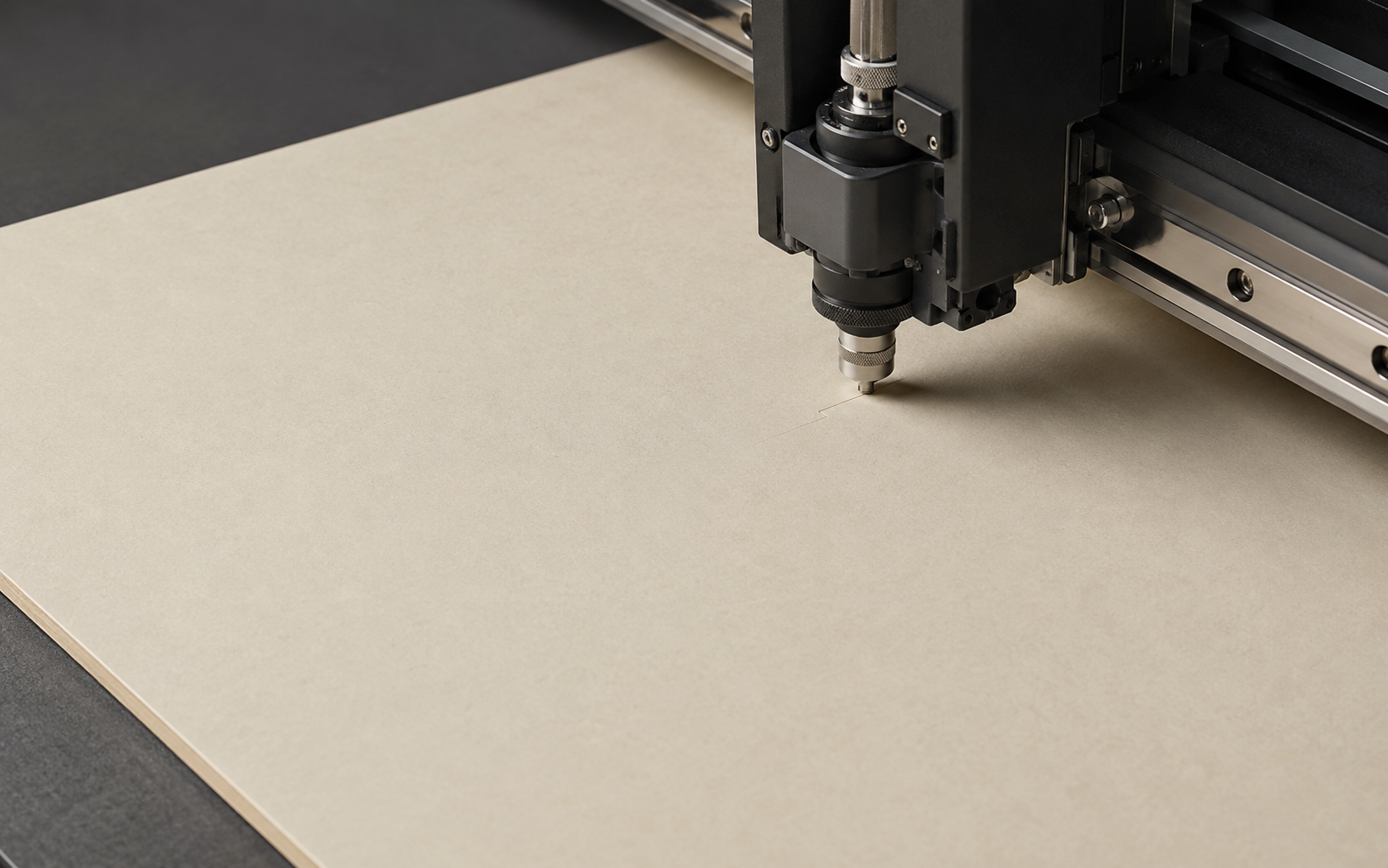 Industrial digital cutting plotter cutting a packaging structure from paperboard.